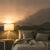 Bedroom with mountain wall mural and lamp on nightstand