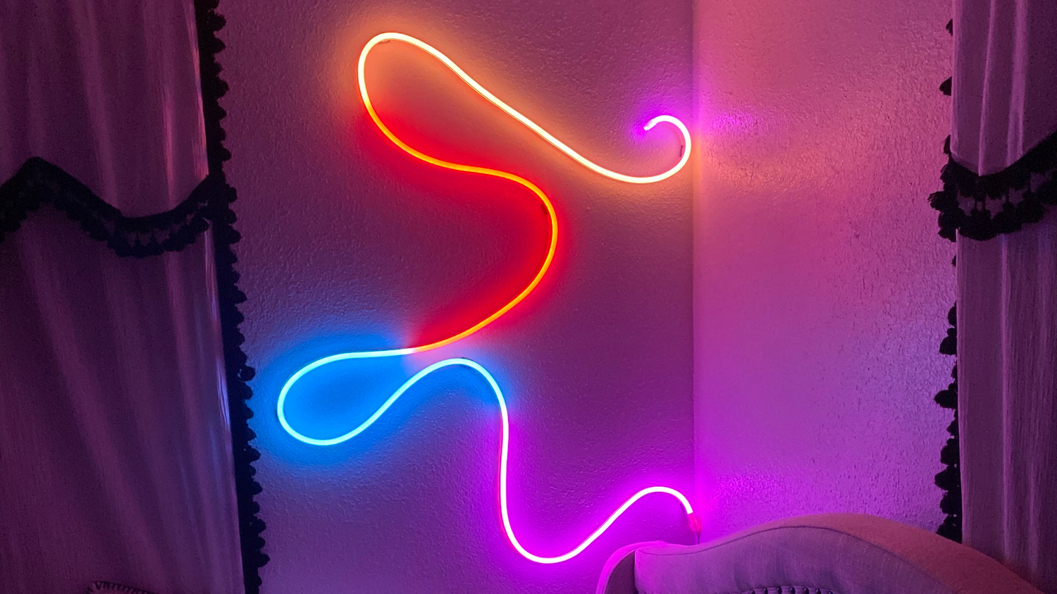 Colorful Feit Electric smart neon flex rope light on bedroom wall.