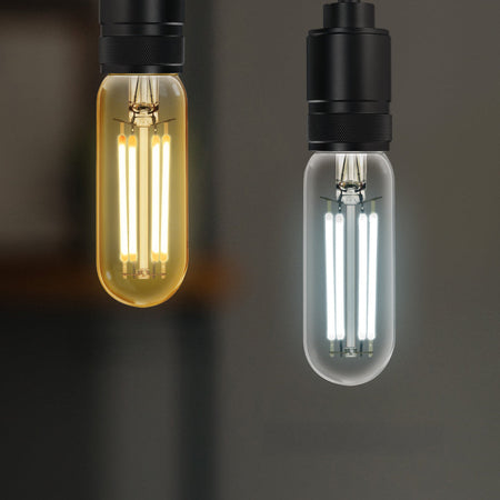 Two light bulbs, one emitting a warm glow and the other a cool white light, on a dark background.