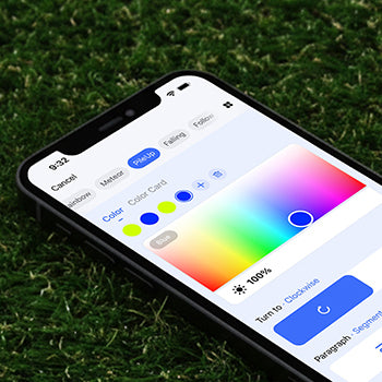 Smartphone displaying a color selection app on a grass background